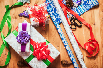Fototapeta premium Objects for wrapping Christmas presents on wooden background 