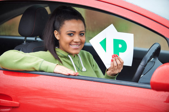 Teenage Girl Recently Passed Driving Test Holding P Plates