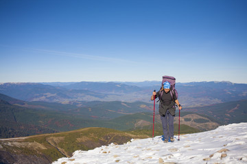 Climber with backpack is the snowy slope.