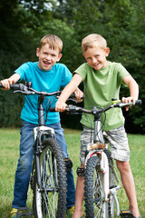 Two Boys Riding Bikes Together