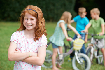 Group Of Children Outdoors Playing On Bikes