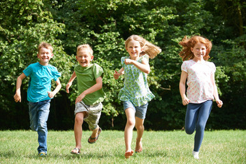 Group Of Children Running Towrads Camera In Playground