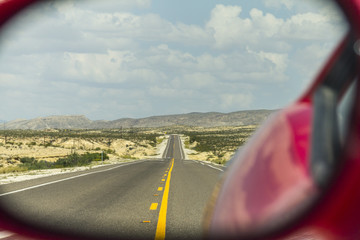 Highway through rear mirror