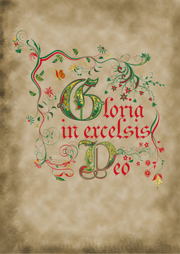 Medieval illuminated manuscript page with ornaments and decorated latin inscription "Glory to God in the highest"