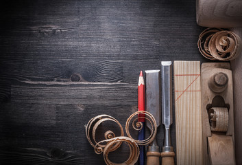 Composition of chisels planer wooden shavings plank hammer penci