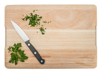 Cutting parsley on a chopping board. Isolated on white background.