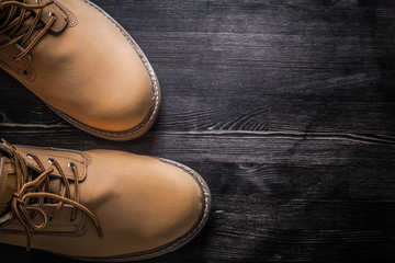 Leather safety working boots on wood board construction concept