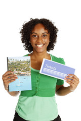 A happy woman holds up a generic travel brochure and generic ticket envelope.