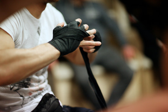 Man wrapping his wrists to protect before the figh