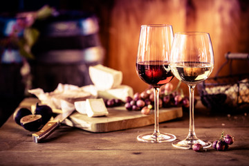 Cheese platter with wine in front of fire - obrazy, fototapety, plakaty