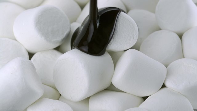 Chocolate sauce on marshmallow shooting with high speed camera.