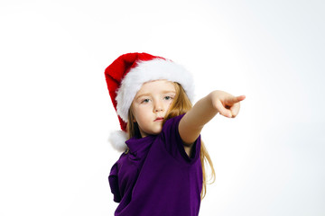 Cute little girl in santa red hat showing by hand