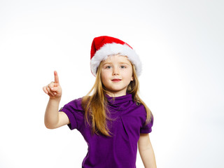 Cute little girl in santa hat touching transparent screen