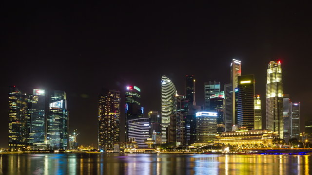 4K video time lapse : Singapore Skyline and view of Marina Bay at night with upward movement.