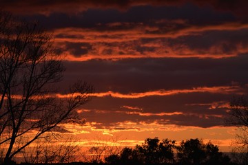 Orange and red sunset from a hilltop