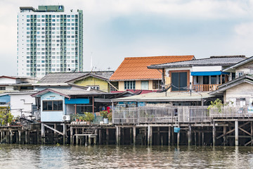 houses on stilts along the river in Bangkok