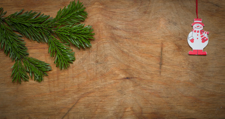 Christmas wooden background decorated with a toy.