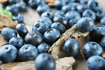 Tasty ripe blueberries on wooden table close up