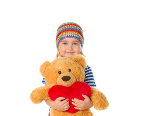 Little girl holding Teddy bear and heart.