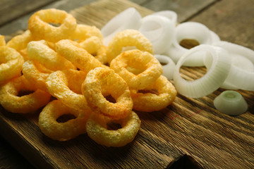 Chips rings with sauce and onion on cutting board