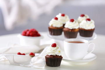 Obraz na płótnie Canvas Beautiful chocolate cupcakes and cup of tea, on table