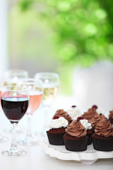 Tasting of wine and chocolate cupcakes, close up