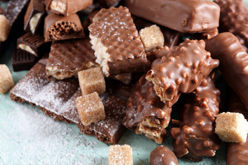 Chocolate sweets with powder on wooden background
