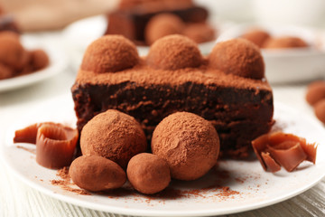 Slices of chocolate cake with a truffle on plate closeup