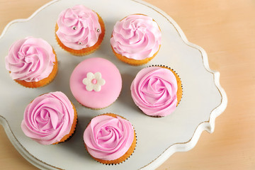 Tasty cupcakes on stand, close-up