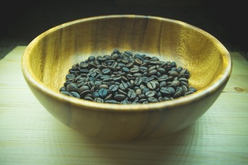 Roasted coffee in a wooden plate