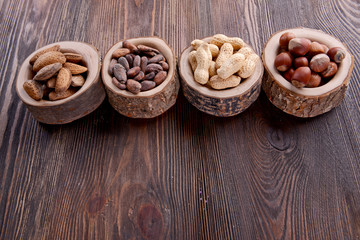 Assortment of tasty nuts on wooden background