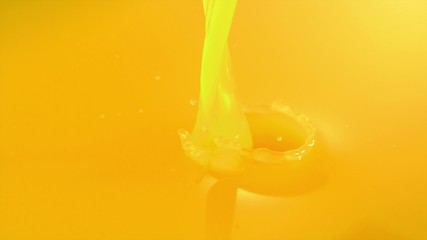 Pouring orange juice shooting with high speed camera.
