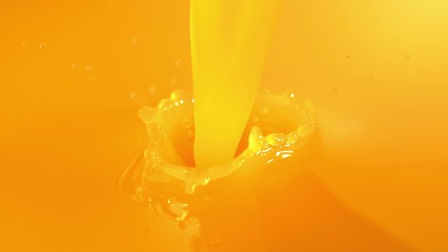 Pouring orange juice shooting with high speed camera.