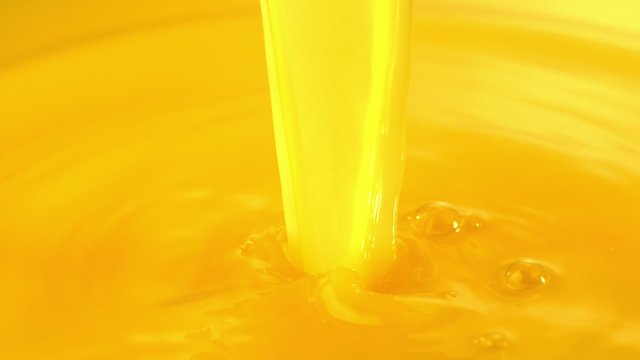 Pouring orange juice shooting with high speed camera.