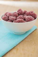 Tamarind candy in white bowl on wooden background