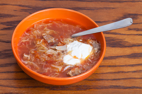 cabbage soup in ceramic bowl with tablespoon