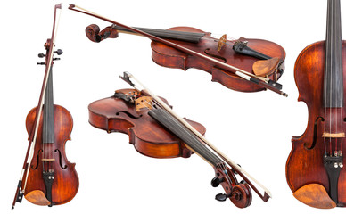 set of old violins with bows isolated on white