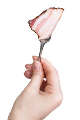 dinning fork with impaled piece of bacon in hand