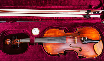 top view of old violin with bow in red velvet case © vvoe