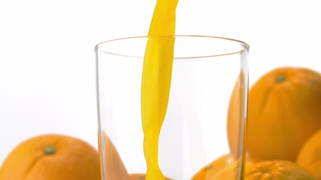 Pouring orange juice into glass shooting with a high speed camera. 