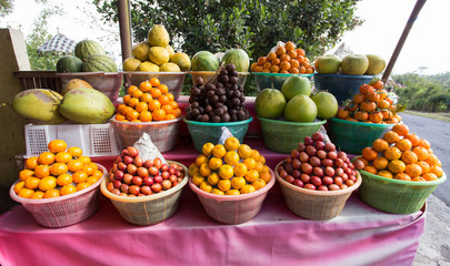tropical fruits in baskets on fruit market