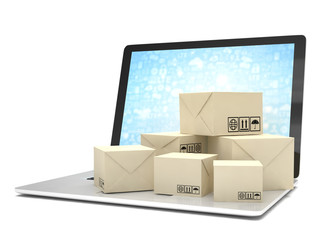 Technology business concept, shipping: cardboard package boxes on laptop