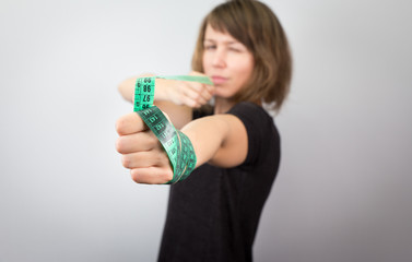 Young woman model measuring meter bow diet studio.