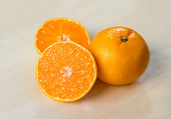 Fresh organic oranges halves fruits on  wooden background