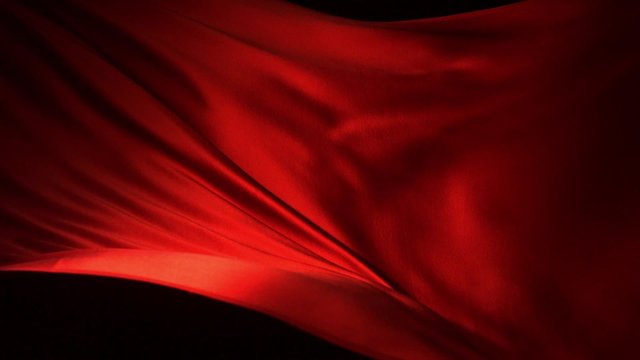 Red silk fabric flying in the air shooting with a high speed camera. 
