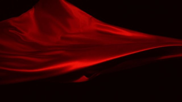Red silk fabric flying in the air shooting with a high speed camera. 