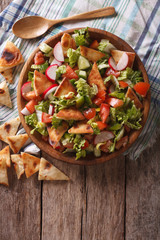 Traditional Arabic fattoush salad on a plate. vertical top view
