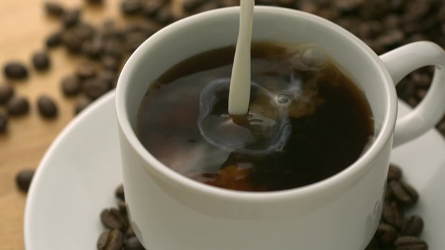 Pouring milk into coffee shooting with high speed camera, phantom flex.