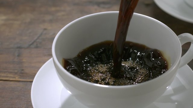 Pouring coffee into cup shooting with high speed camera, phantom flex.