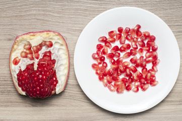 One part of the garnet on the table and seeds of the garnet on t